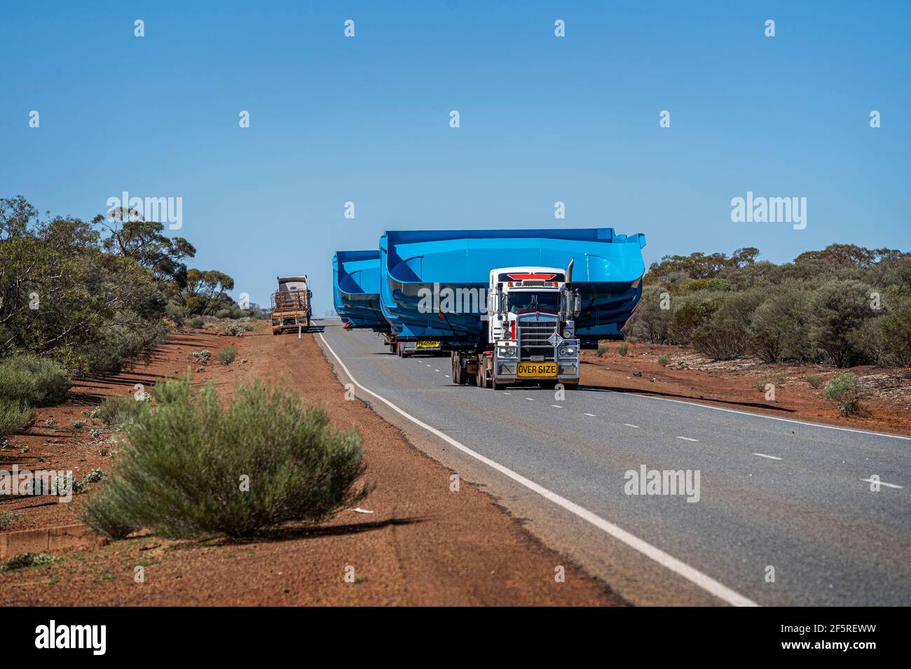 Heavy mine machinery being transported by road train trucks, Western Australia Stock Photo