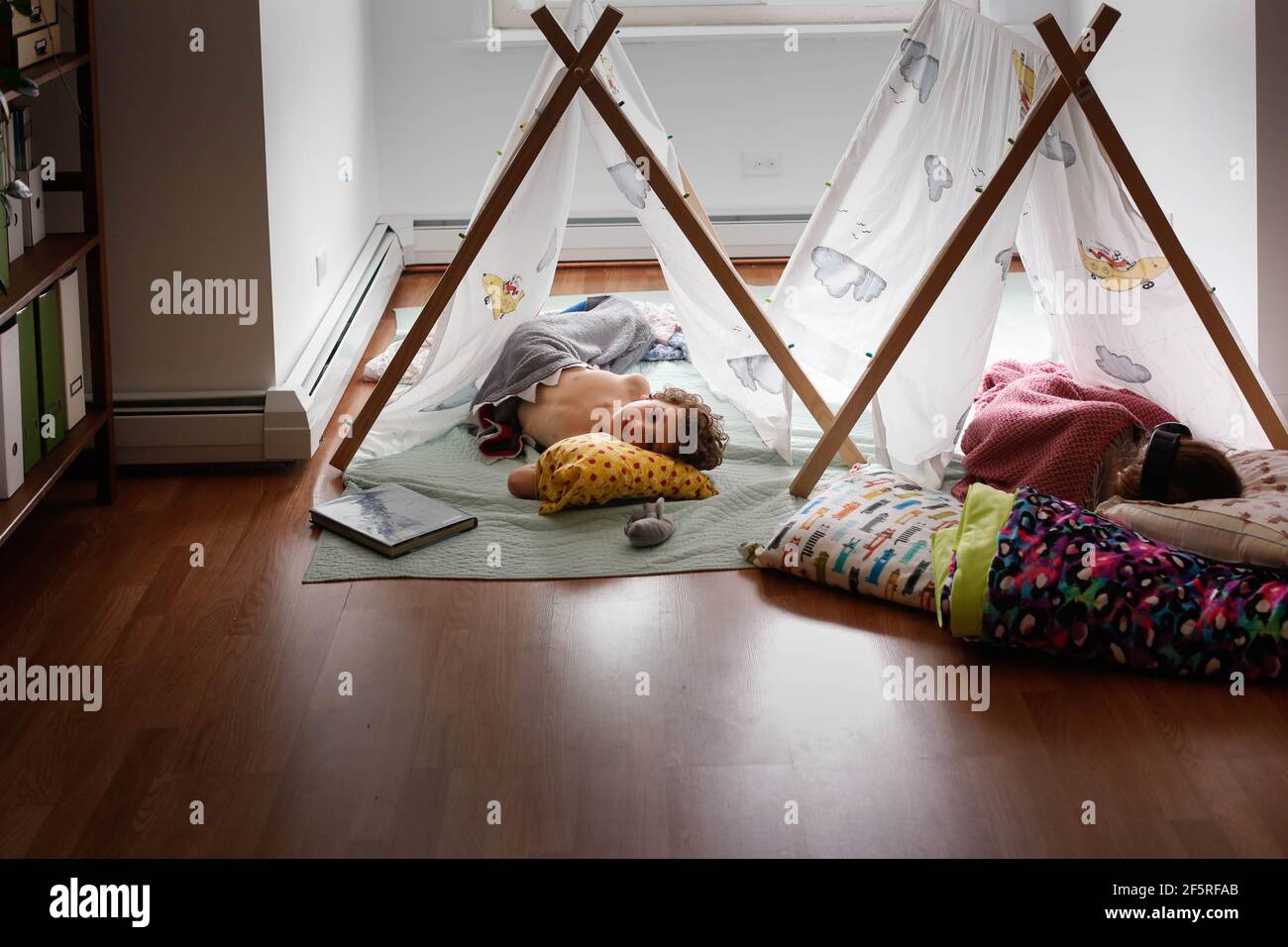Two sleeping kids inside in tents Stock Photo