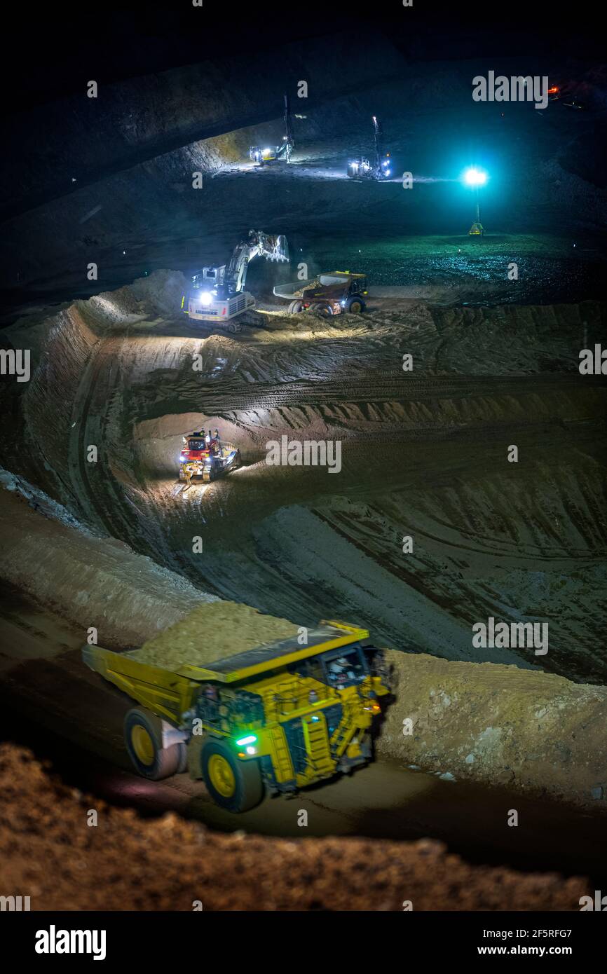 Open Pit Mining Operation At Night With Drill Rigs, Dump Trucks And ...