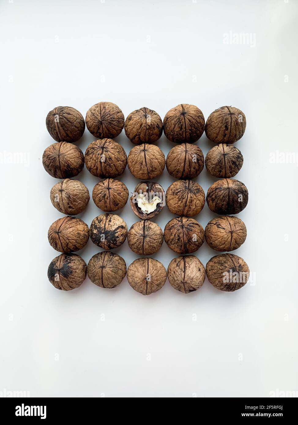 Flat lay whole and cracked walnuts on a white background Stock Photo