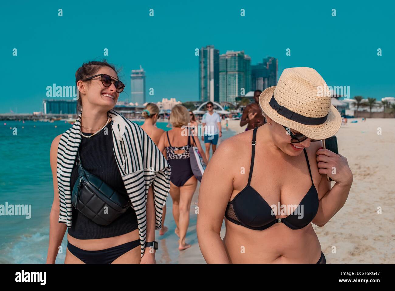 pretty women enjoying life on vacation at seaside walking and laughing Stock Photo