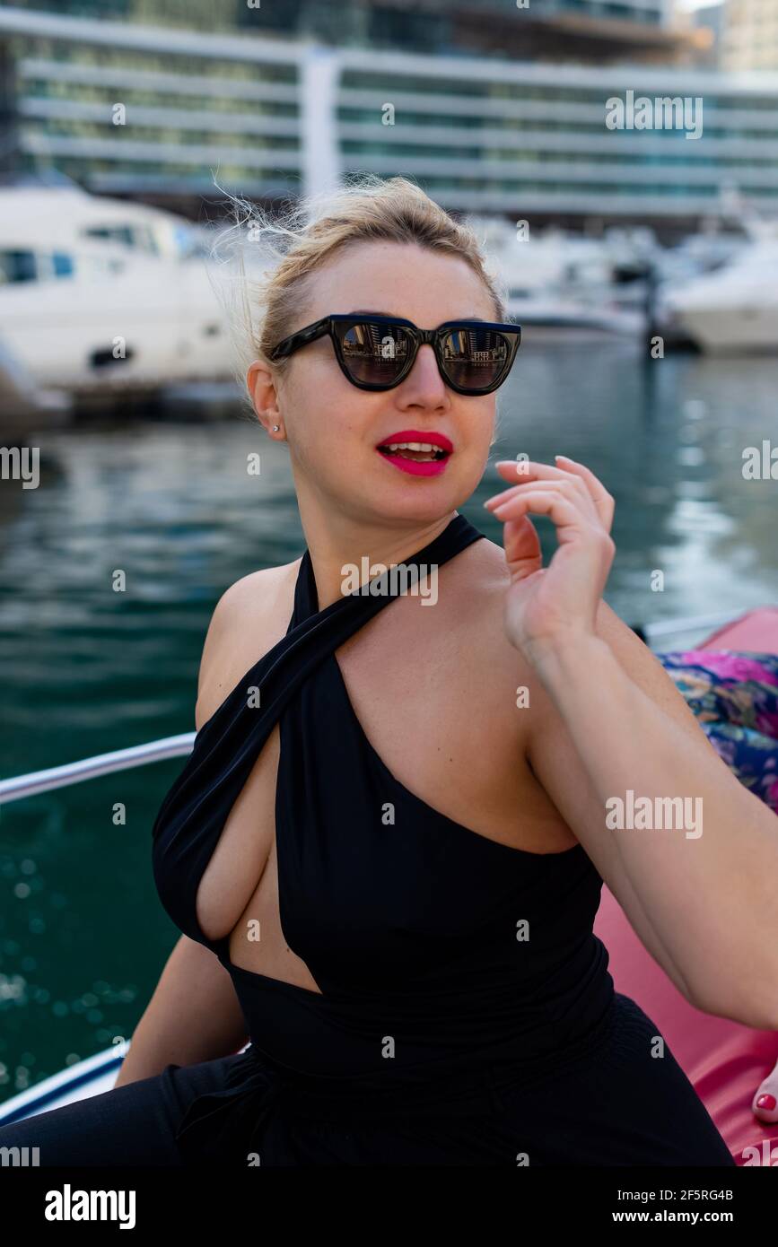 beautiful lady romantically looking aside like in movie on boat Stock Photo