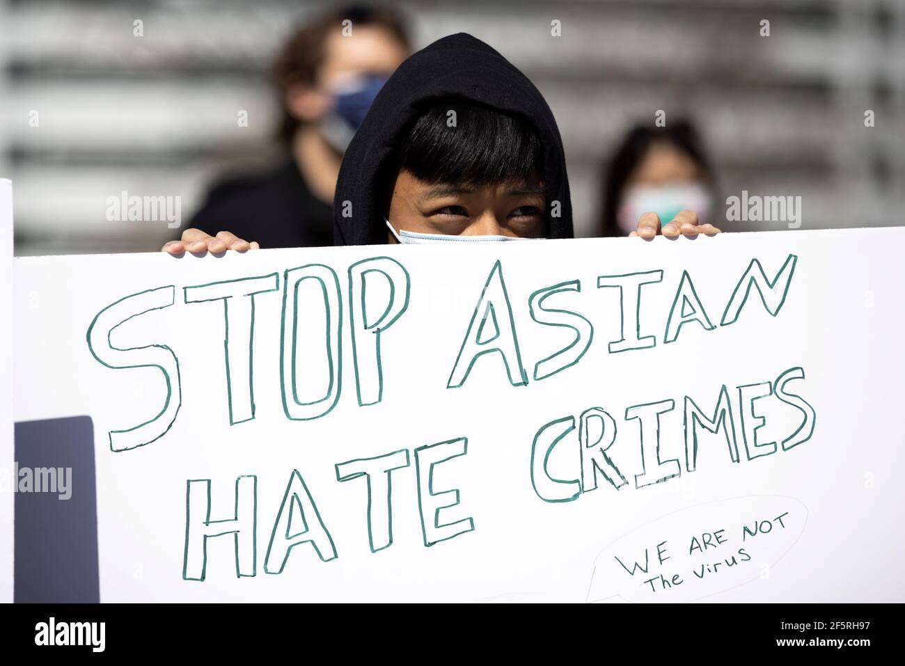 Caillou Yang, 15, holds a sign at the Colorado State Capitol during a rally  against anti-Asian hate crimes in Denver Colorado, . March 27, 2021. The  rally was held in response to