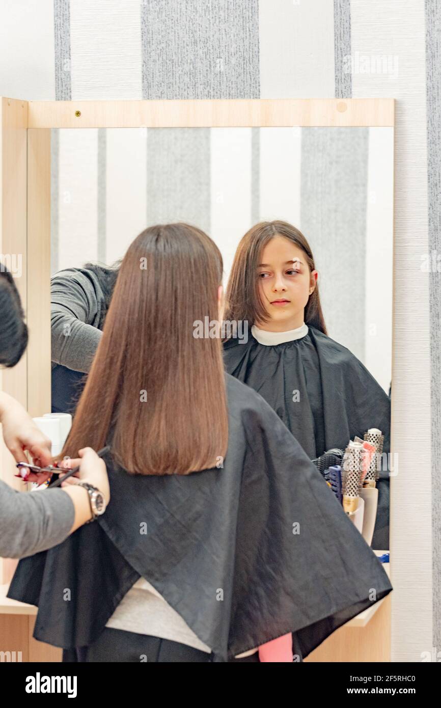 Happy Girl Getting her Hair Cut. A series of photos of a girl getting her hair  cut. haircut, girl Stock Photo - Alamy