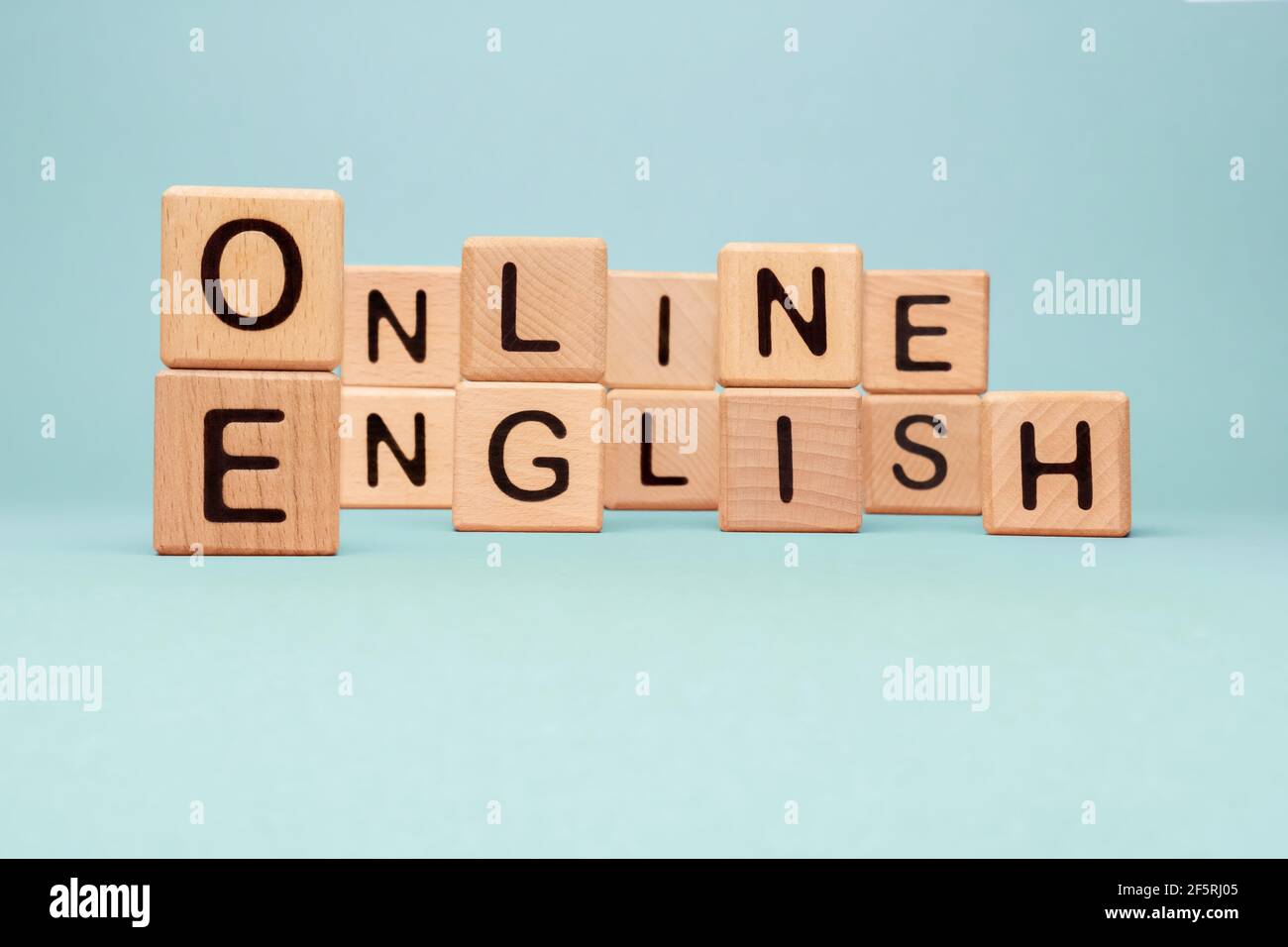 Word Online English letters blocks toy cubes. Speak English Online course icon wooden blocks concept foreign language tutoring. Learning Online Stock Photo