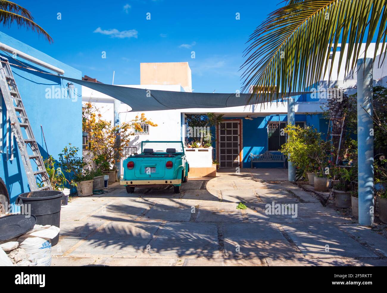 Blue House - A cute example of bright homes and cars in southern countries Stock Photo