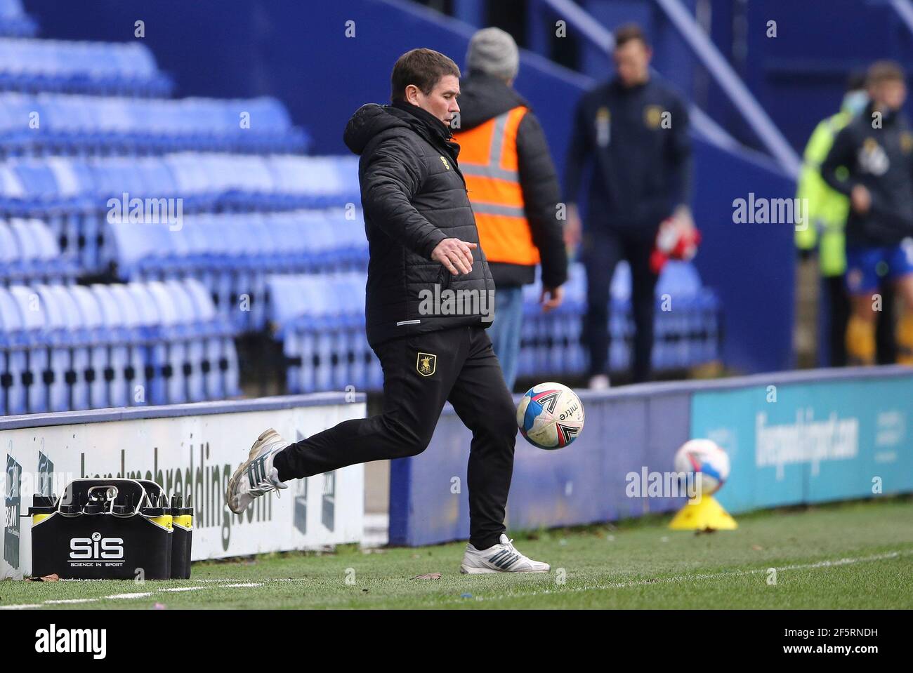 Birkenhead, UK. 27th Mar, 2021. Mansfield Town Manager Nigel Clough kick the ball. EFL Skybet Football league two match, Tranmere Rovers v Mansfield Town at Prenton Park, Birkenhead, Wirral on Saturday 27th March 2021. this image may only be used for Editorial purposes. Editorial use only, license required for commercial use. No use in betting, games or a single club/league/player publications.pic by Chris Stading/Andrew Orchard sports photography/Alamy Live News Credit: Andrew Orchard sports photography/Alamy Live News Stock Photo