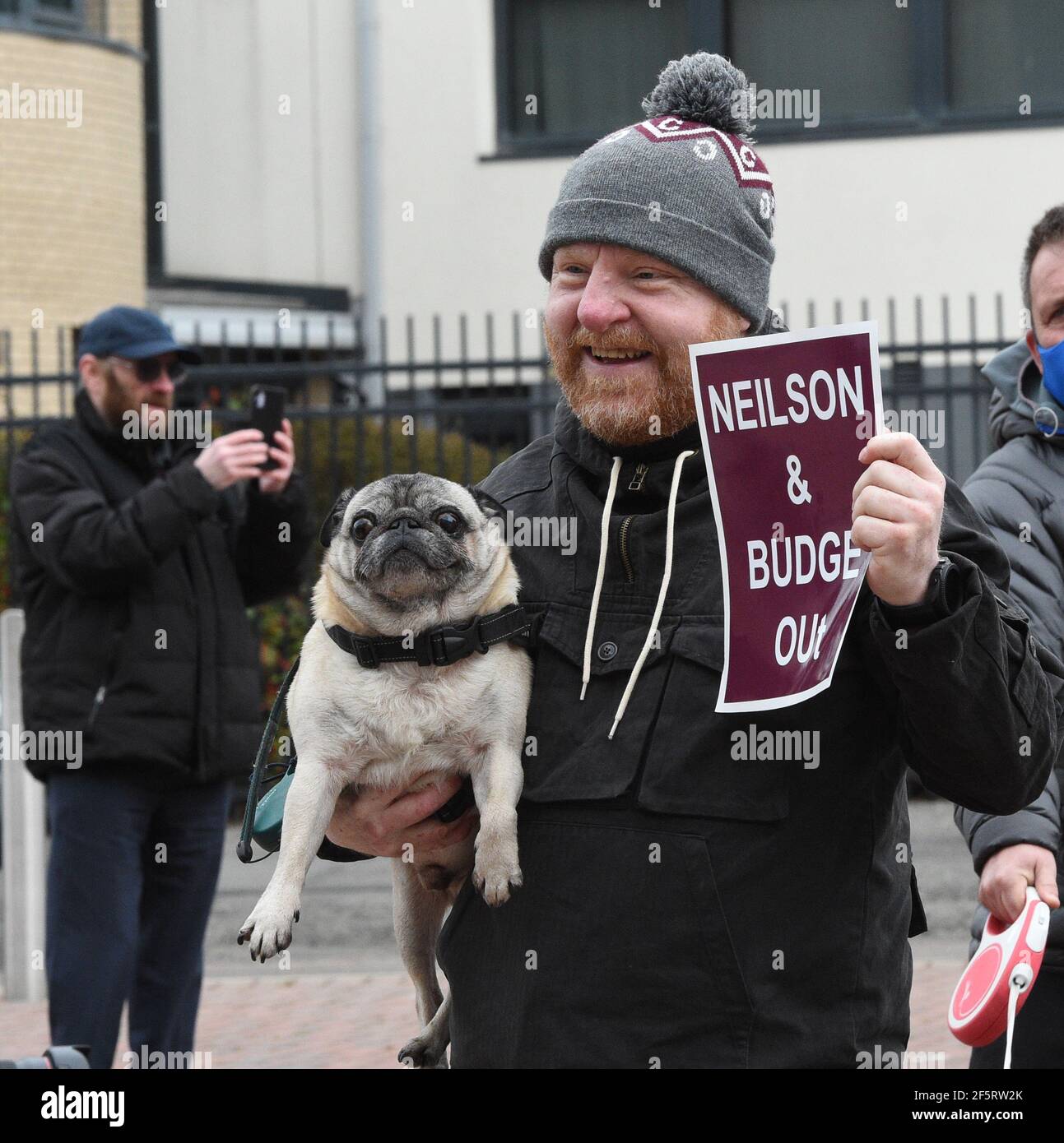 Tynecastle Park, Edinburgh, Scotland. UK 27th March-21. Scottish Championship Match .Hearts vs Queen of the South. Pics shows One man and dog Hearts Fans protest at Tynecastle Credit: eric mccowat/Alamy Live News Stock Photo