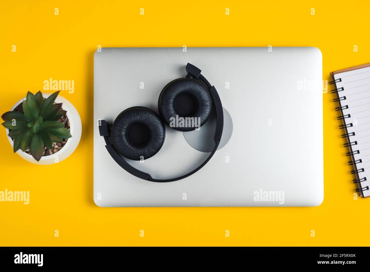 Headphones lie on notebook. Stock Photo