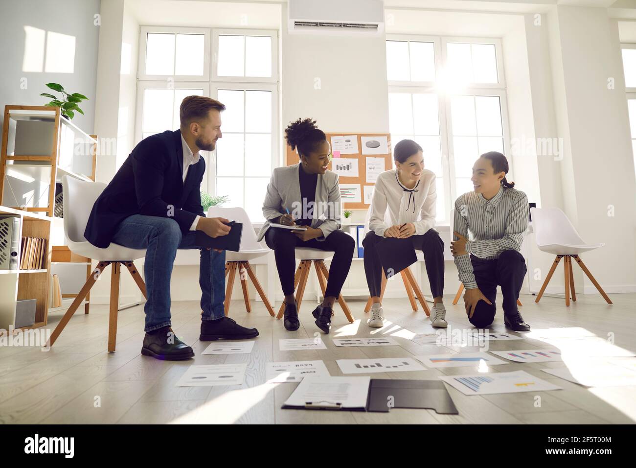 Team of young business professionals developing new strategies in an office meeting Stock Photo