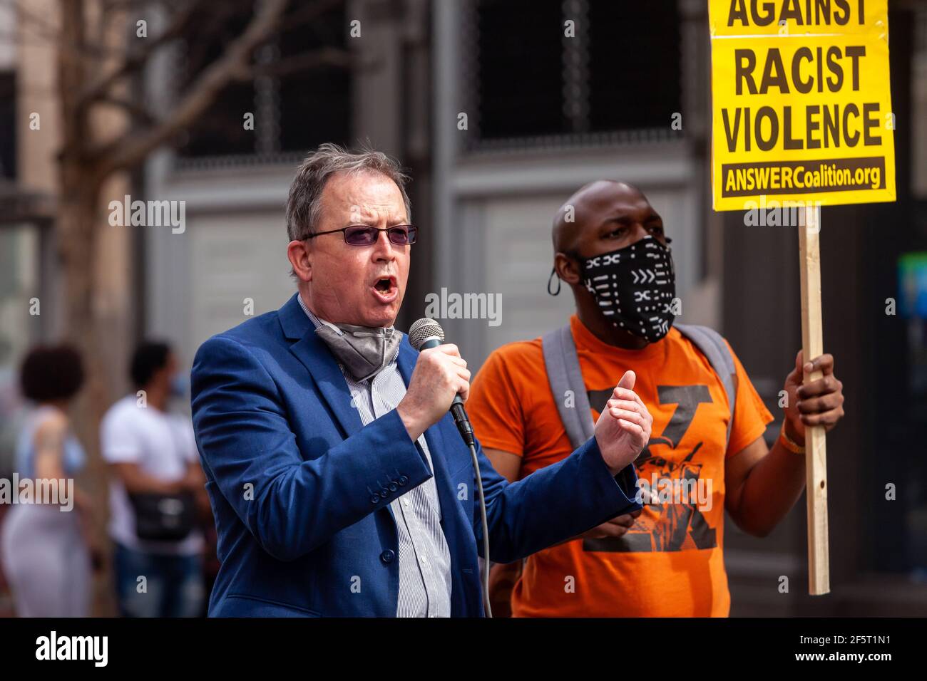 Washington, DC, USA, 27 March, 2021.  Pictured: Brian Becker, National Director of ANSWER Coalition, concludes the organization's National Day of Action to Stop Anti-Asian Violence in Chinatown.  Credit: Allison C Bailey/Alamy Live News Stock Photo