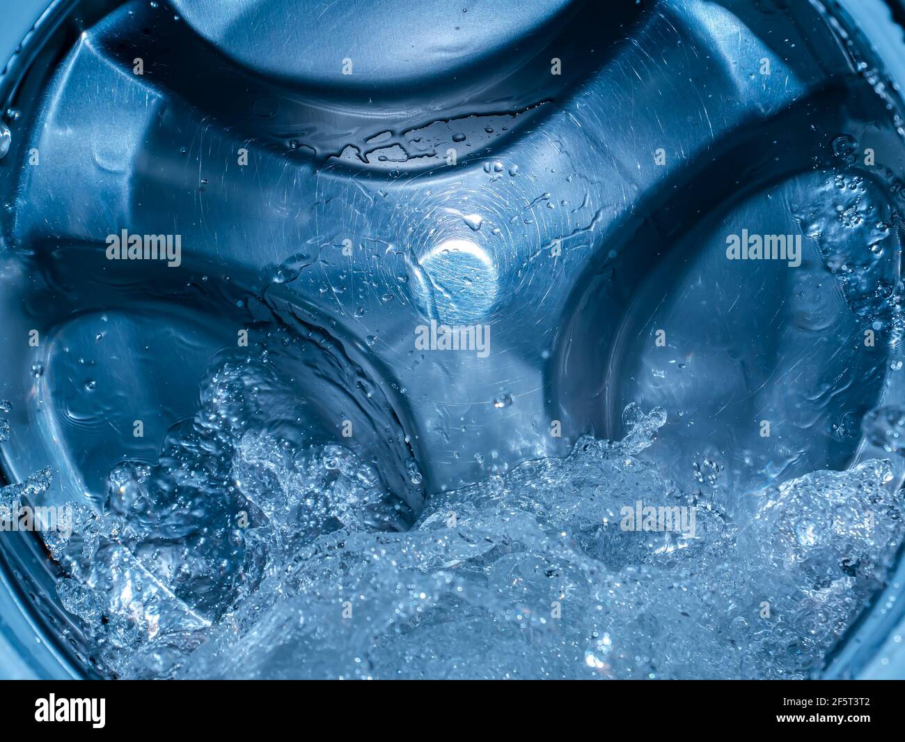 Rotating drum in the washing machine tub with water. Washer. Automatic laundry. Service and