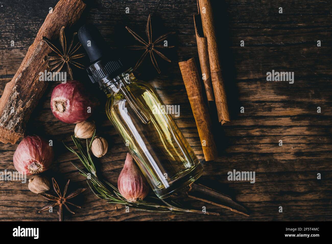 Herbal oil extract for food or aroma on wooden table decoration with scent herb. Stock Photo