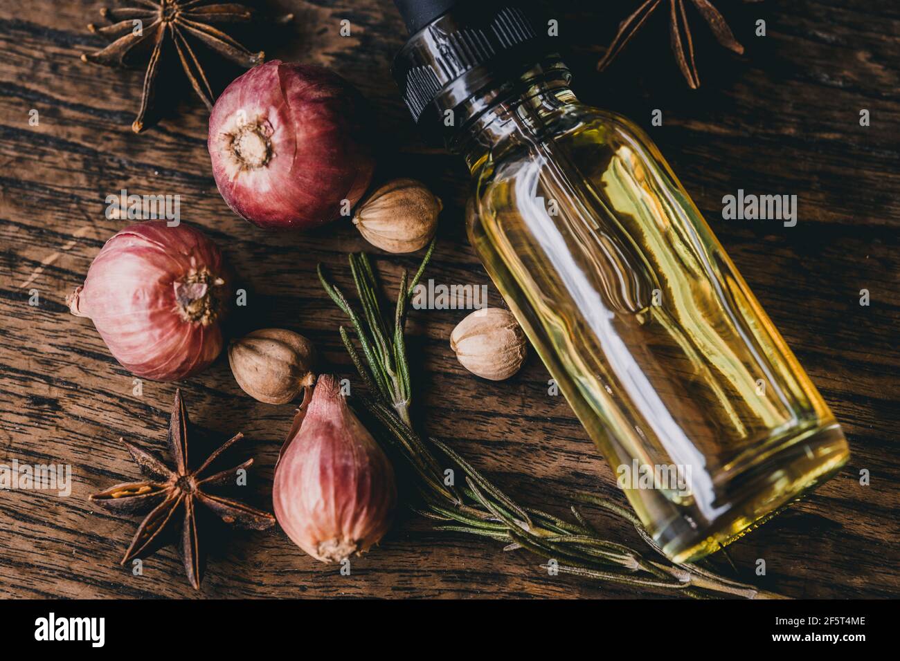 Herbal oil extract for food or aroma on wooden table decoration with scent herb. Stock Photo
