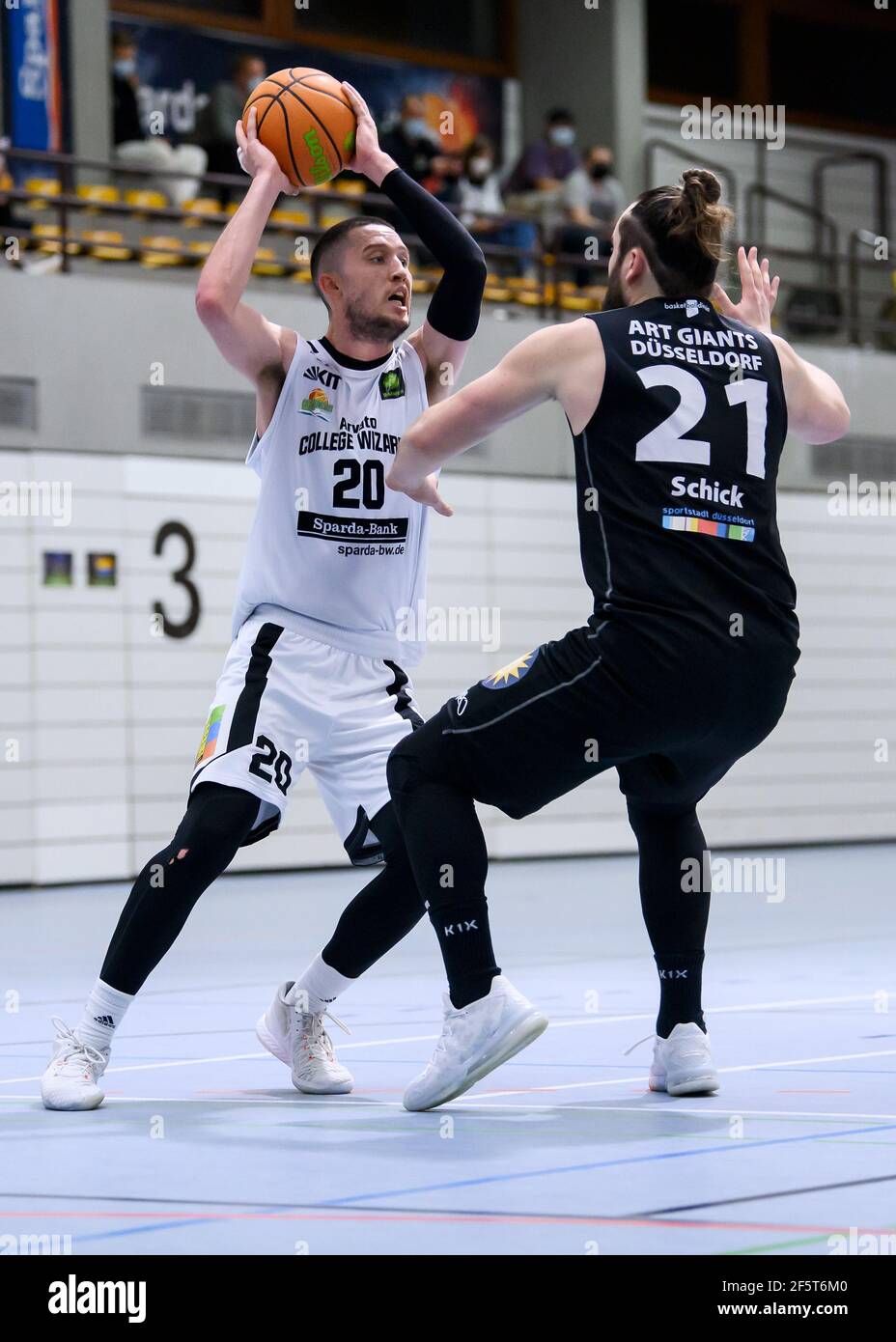 Karlsruhe, Deutschland. 27th Mar, 2021. Alexander Thompson (Wizards) in  duels with Marian Schick (Duesseldorf). GES/Basketball/