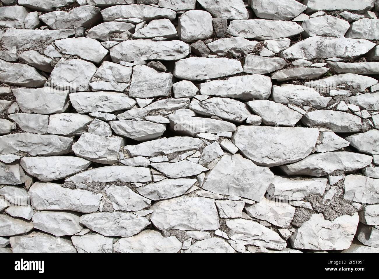 Carrara marble stone random rubble masonry texture. Colonnata. Tuscany. Italy. Stock Photo