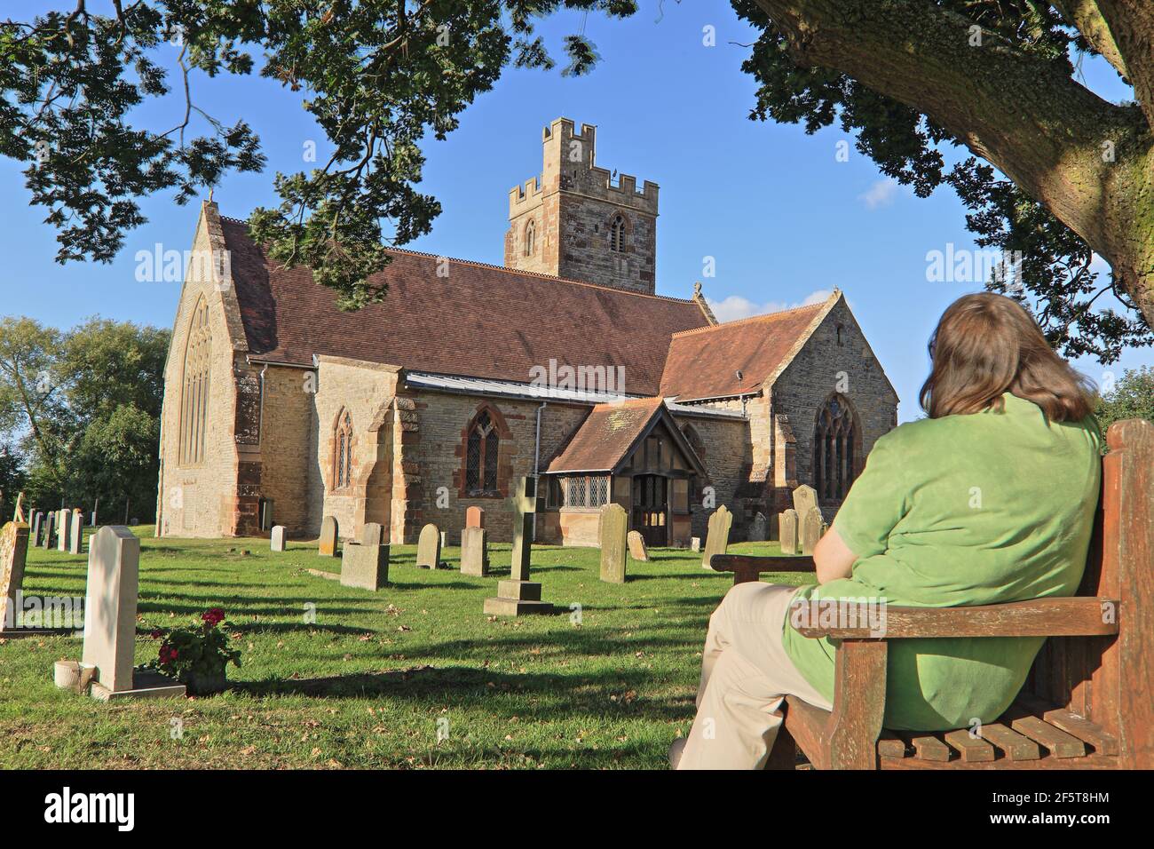 Solitude in the churchyard of St Denys' Church, Severn Stoke, Worcestershire, England, UK. Stock Photo
