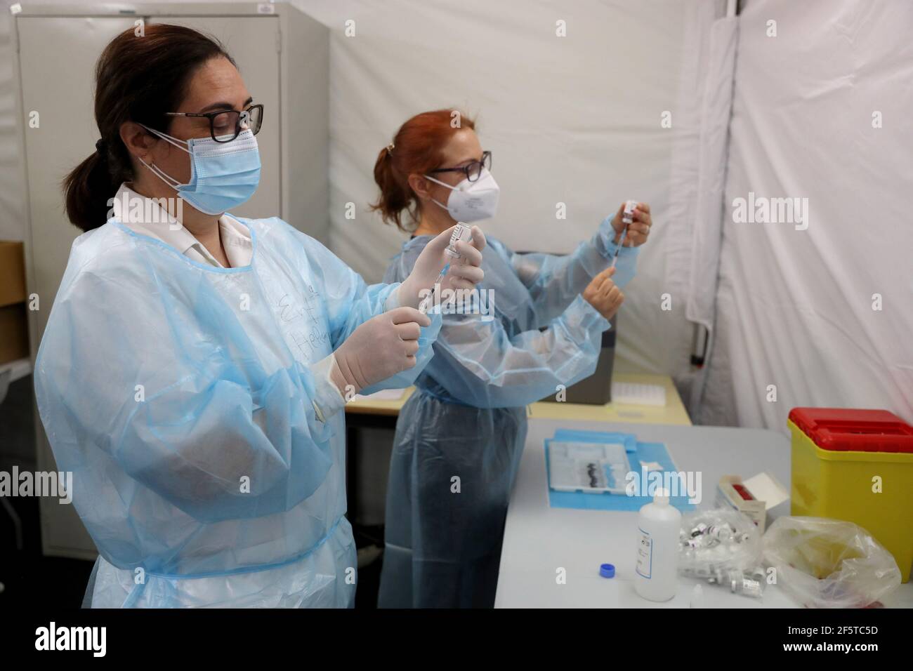 Lisbon, Portugal. 27th Mar, 2021. Medical workers fill up syringes with the AstraZeneca COVID-19 vaccine in Lisbon, Portugal, March 27, 2021. Portugal on Saturday started vaccinations of some 78,700 teachers and workers from pre-schools and schools of the first four years of the nine-year basic education. They are listed as one of the priority groups for the resumption of classes. Credit: Pedro Fiuza/Xinhua/Alamy Live News Stock Photo