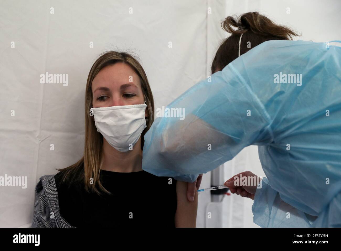 Lisbon, Portugal. 27th Mar, 2021. A teacher receives a dose of the AstraZeneca COVID-19 vaccine in Lisbon, Portugal, March 27, 2021. Portugal on Saturday started vaccinations of some 78,700 teachers and workers from pre-schools and schools of the first four years of the nine-year basic education. They are listed as one of the priority groups for the resumption of classes. Credit: Pedro Fiuza/Xinhua/Alamy Live News Stock Photo