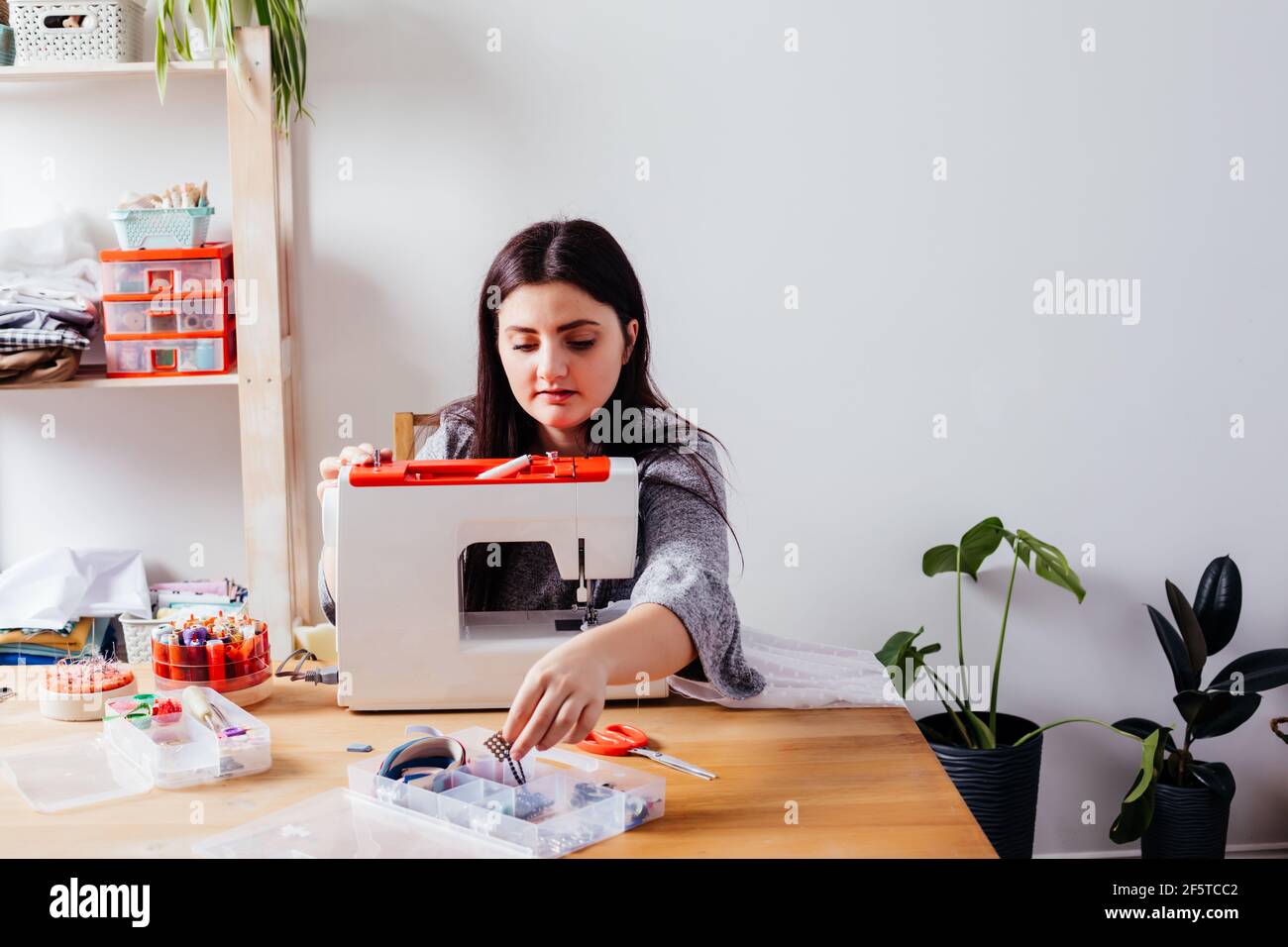 Wedding dressmaker altering white vintage wedding dress Stock Photo Alamy