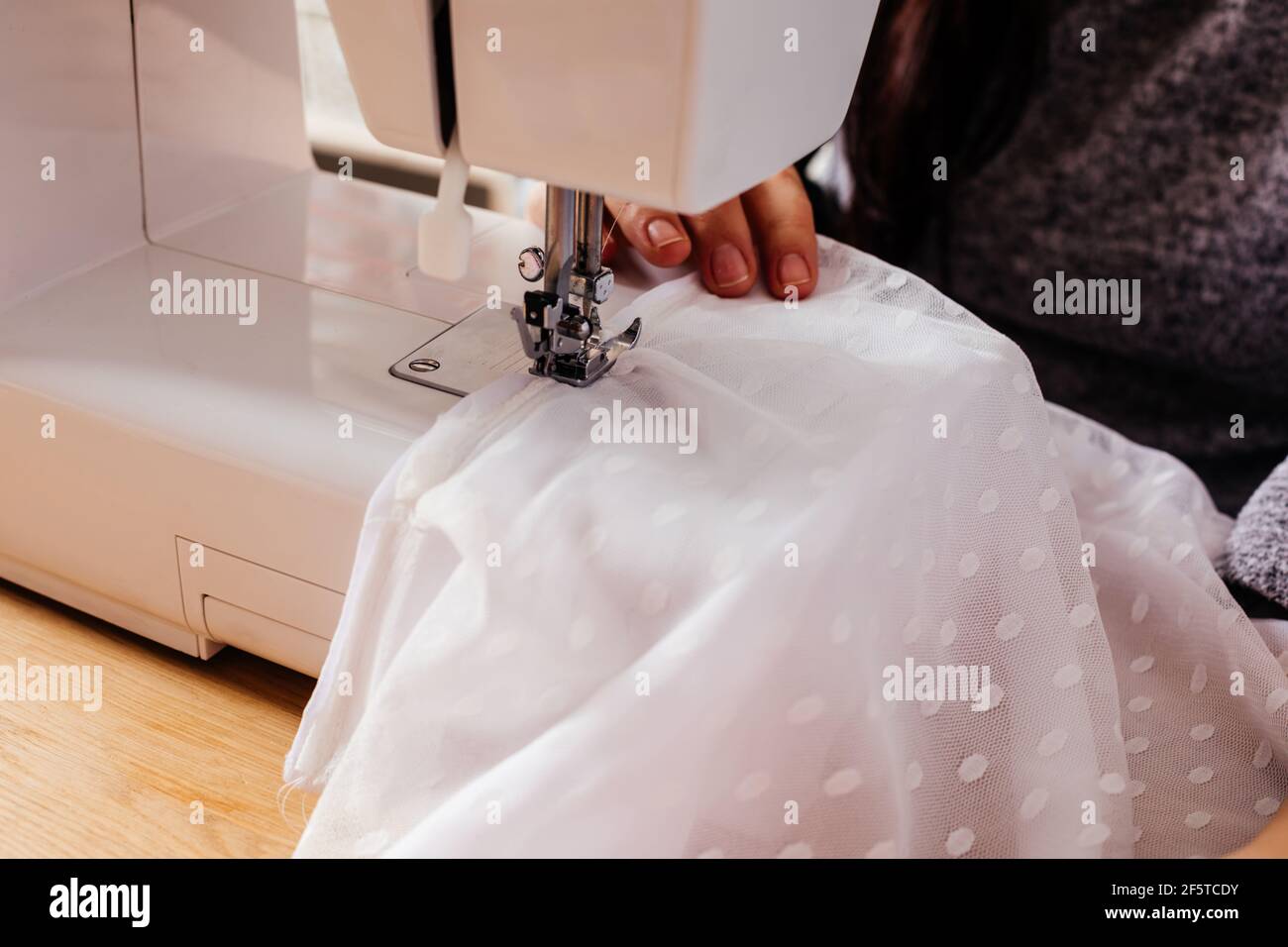 Wedding dressmaker altering white vintage wedding dress Stock Photo Alamy