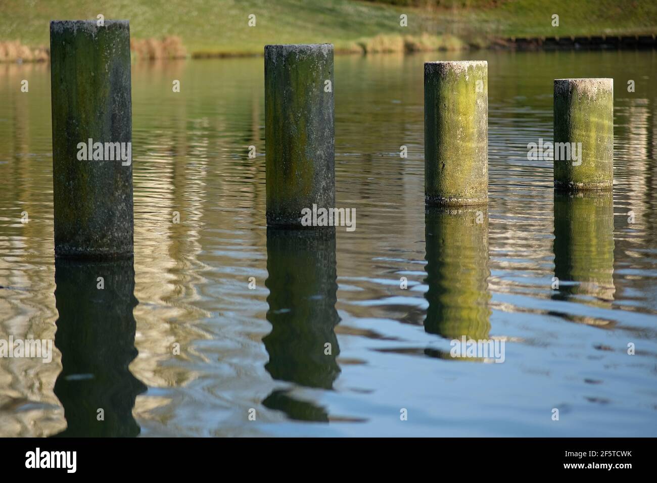 Close up of water reflection of columns installed in a lake in France Stock Photo
