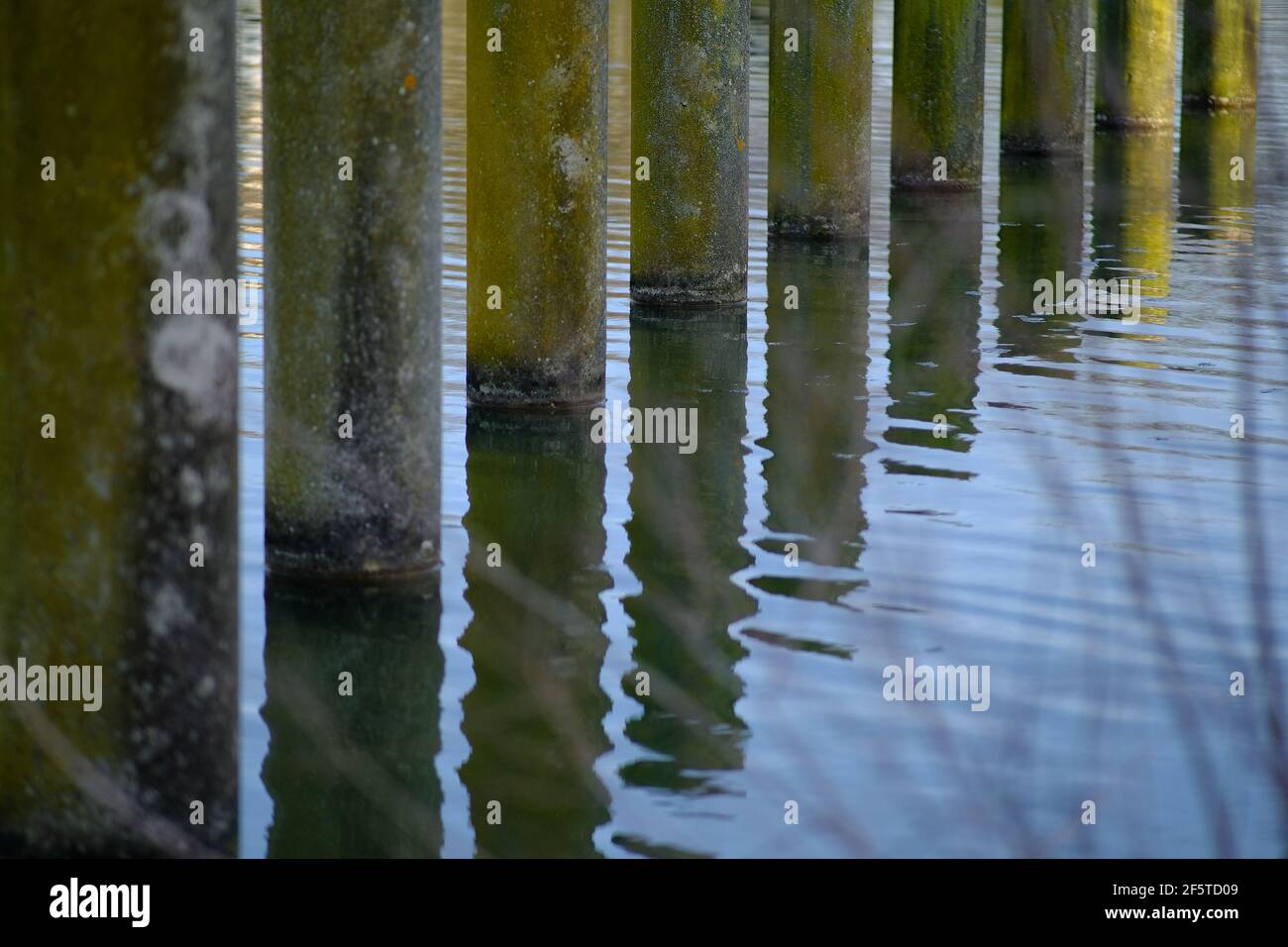 Close up of water reflection of columns installed in a lake in France Stock Photo