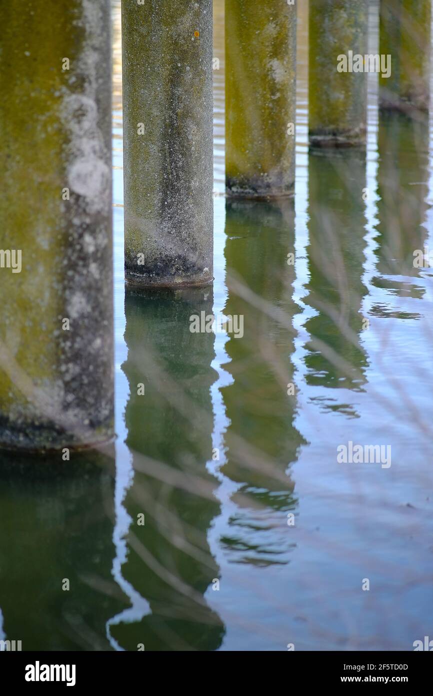 Close up of water reflection of columns installed in a lake in France Stock Photo