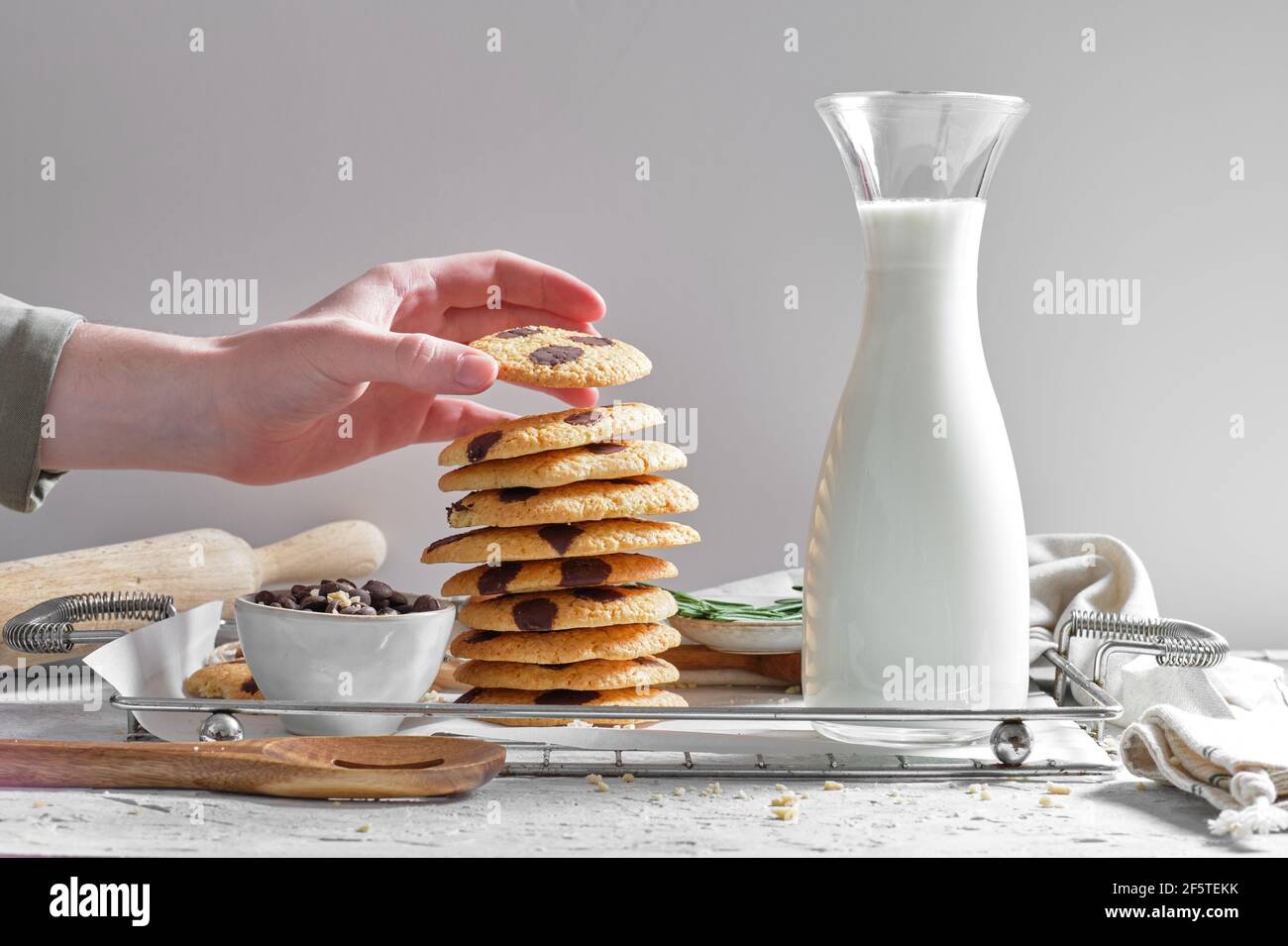 Crop anonymous housewife stacking delicious homemade cookies with ...