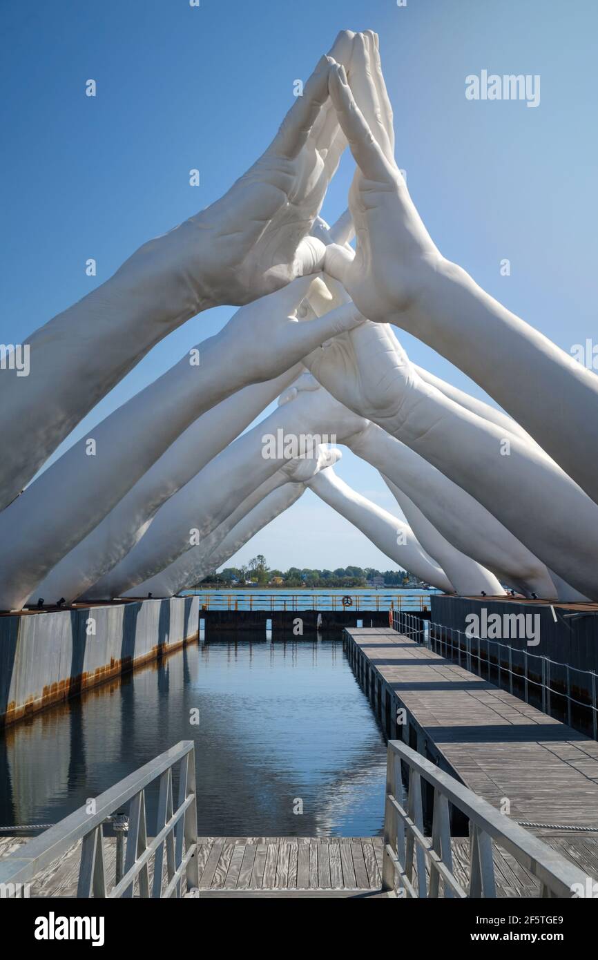 Huge white hands of Building Bridges sculpture by Lorenzo Quinn in the Biennale Art Exhibition Arsenale in Venice Stock Photo