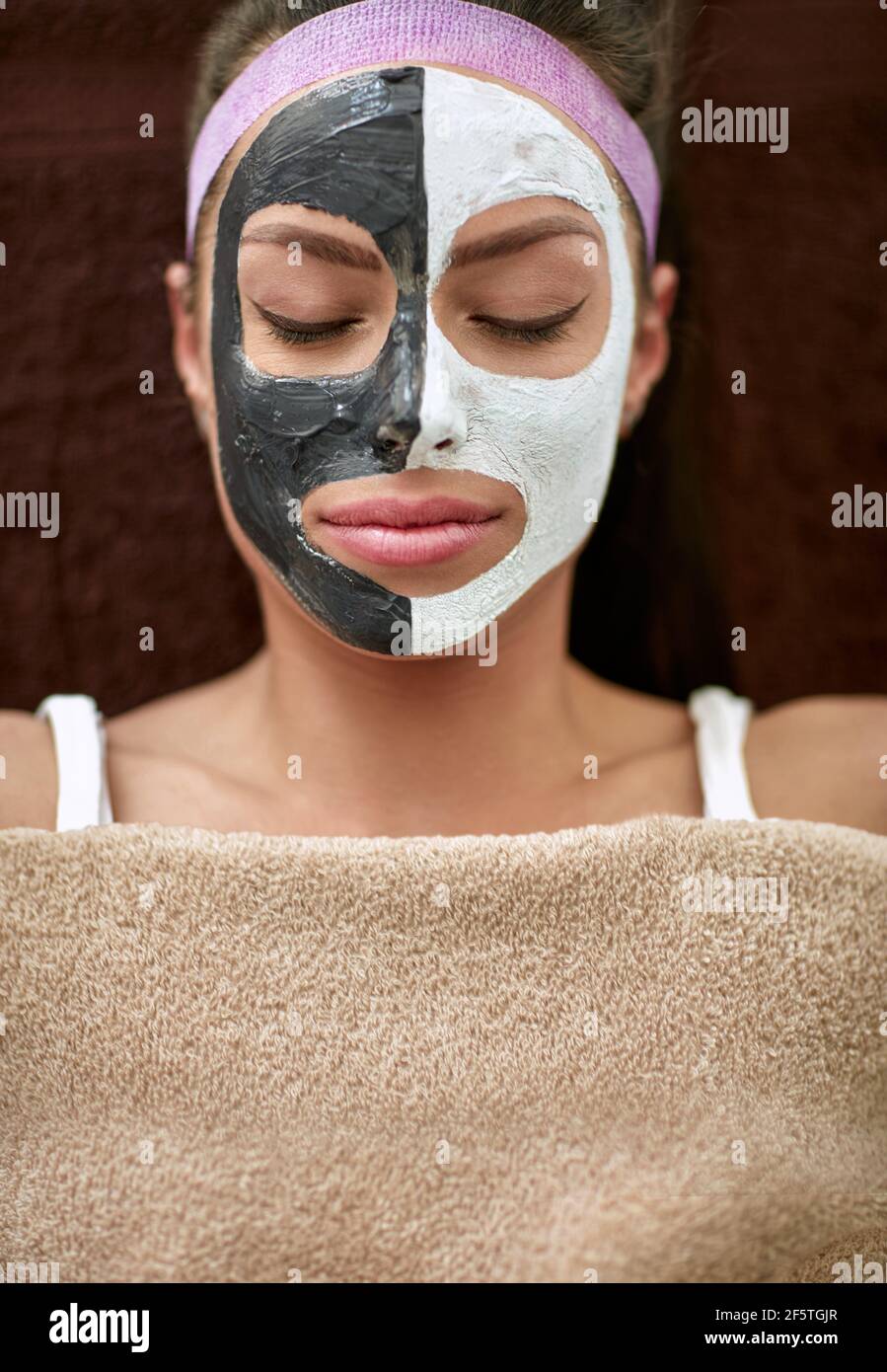 Combined cosmetic facial mask, serene woman enjoying in treatment Stock