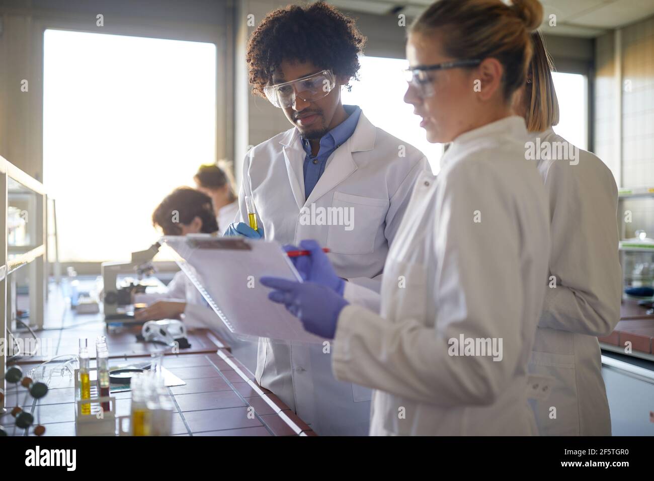 Young chemistry students work in a relaxed atmosphere in the university laboratory. Science, chemistry, lab, people Stock Photo