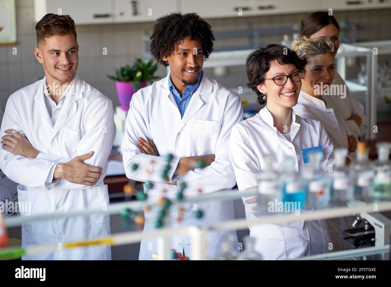 Young scientists posing for a photo in the sterile laboratory environment. Science, chemistry, lab, people Stock Photo