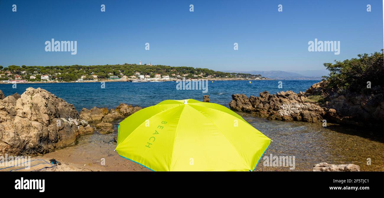 panorama of coast with bright green sun parasol Antibes, South of France Stock Photo