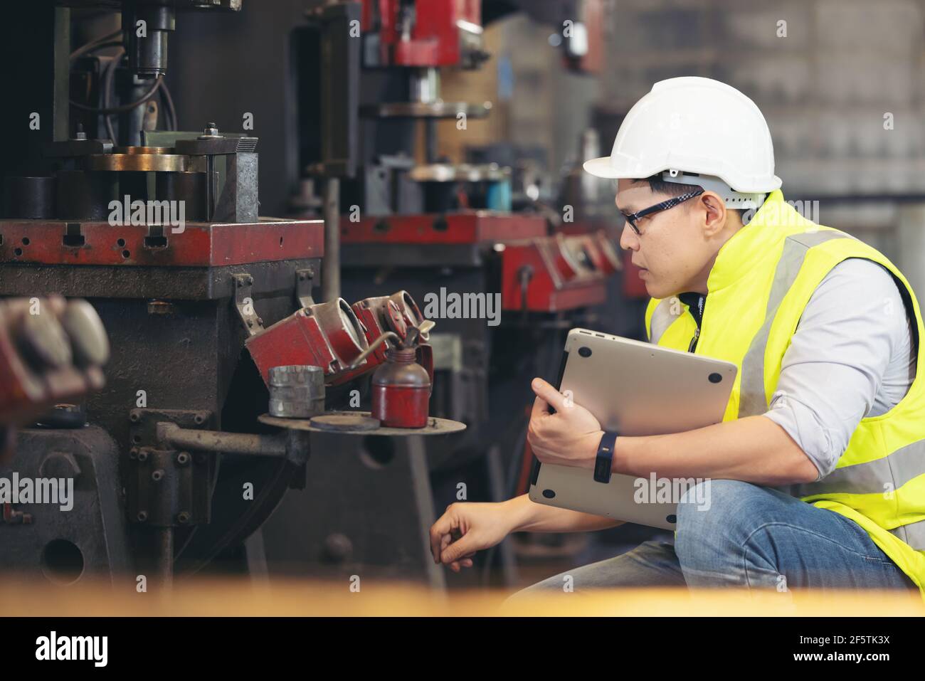 engineer man, or technicians wearing surgical mask and using computer notebook for Checking Stock Photo