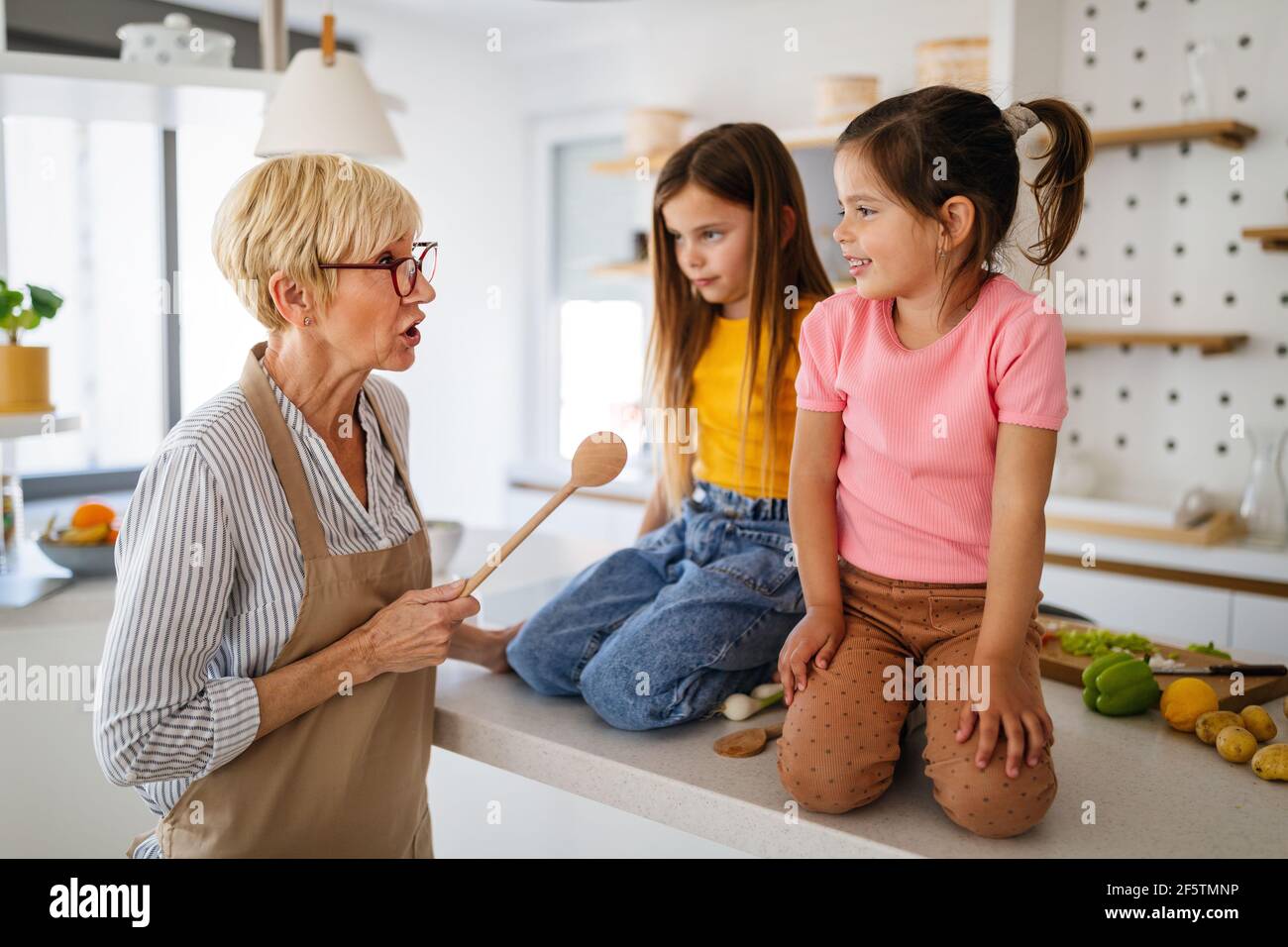 Grandmother is scolding her grandchildrens girls. Family, punishment, discipline concept Stock Photo