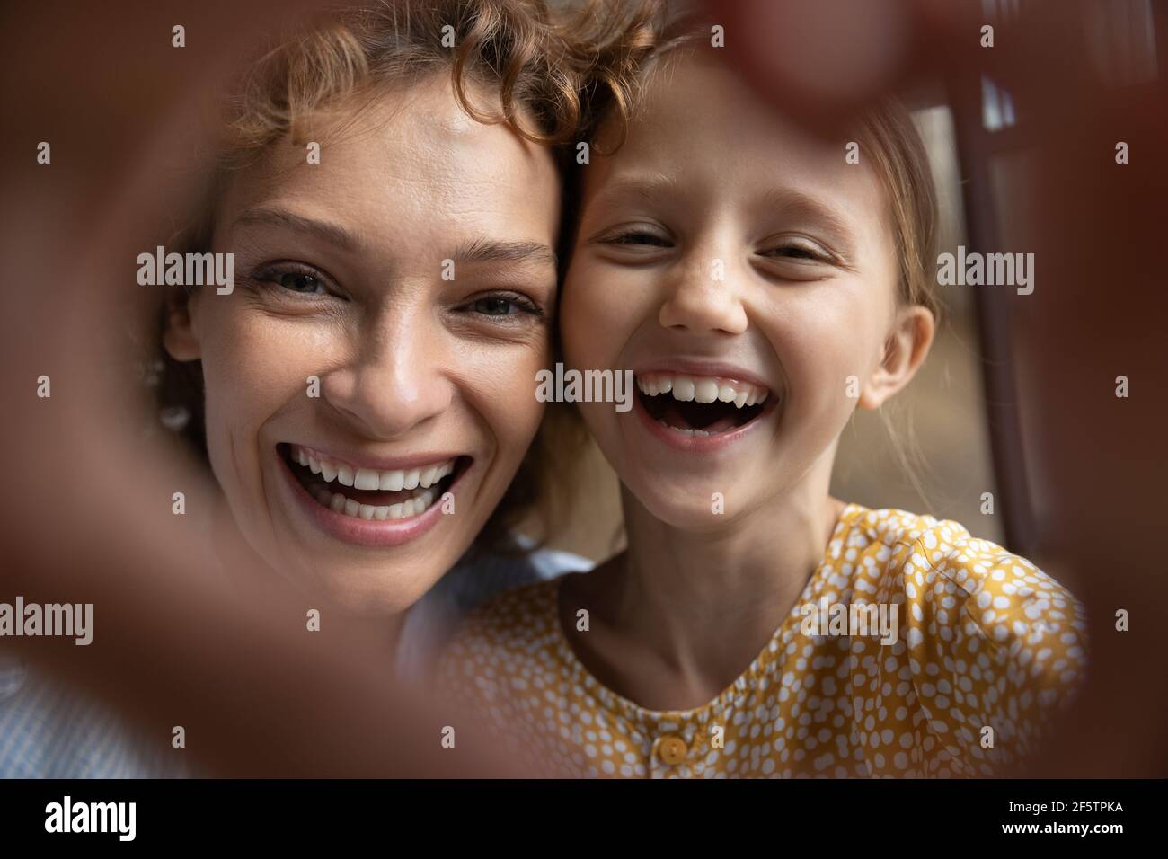 Happy young mom and little daughter take selfie Stock Photo