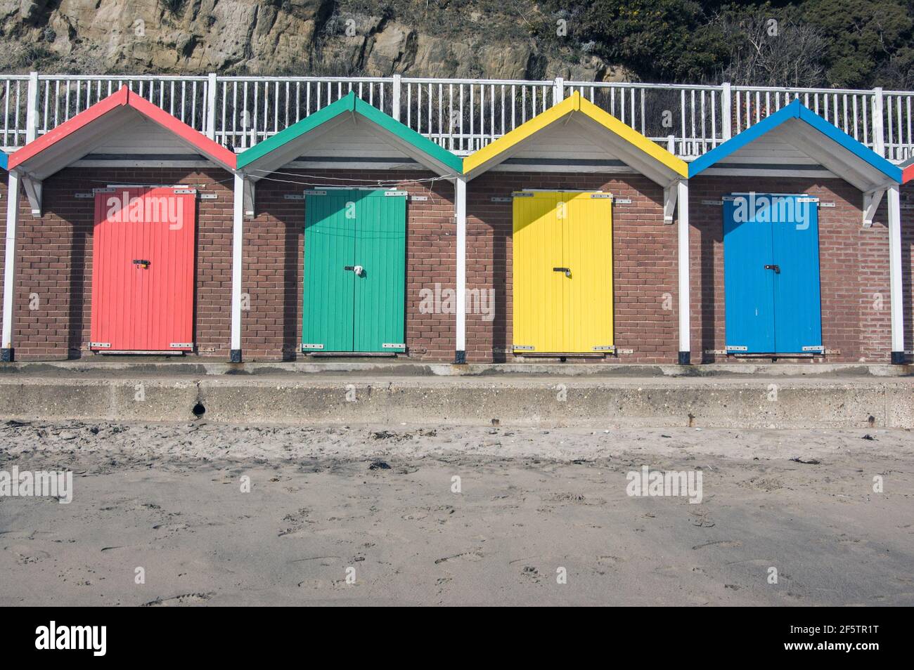 Multi-coloured doors to beach huts on the beach at Swanage, Dorset. Stock Photo