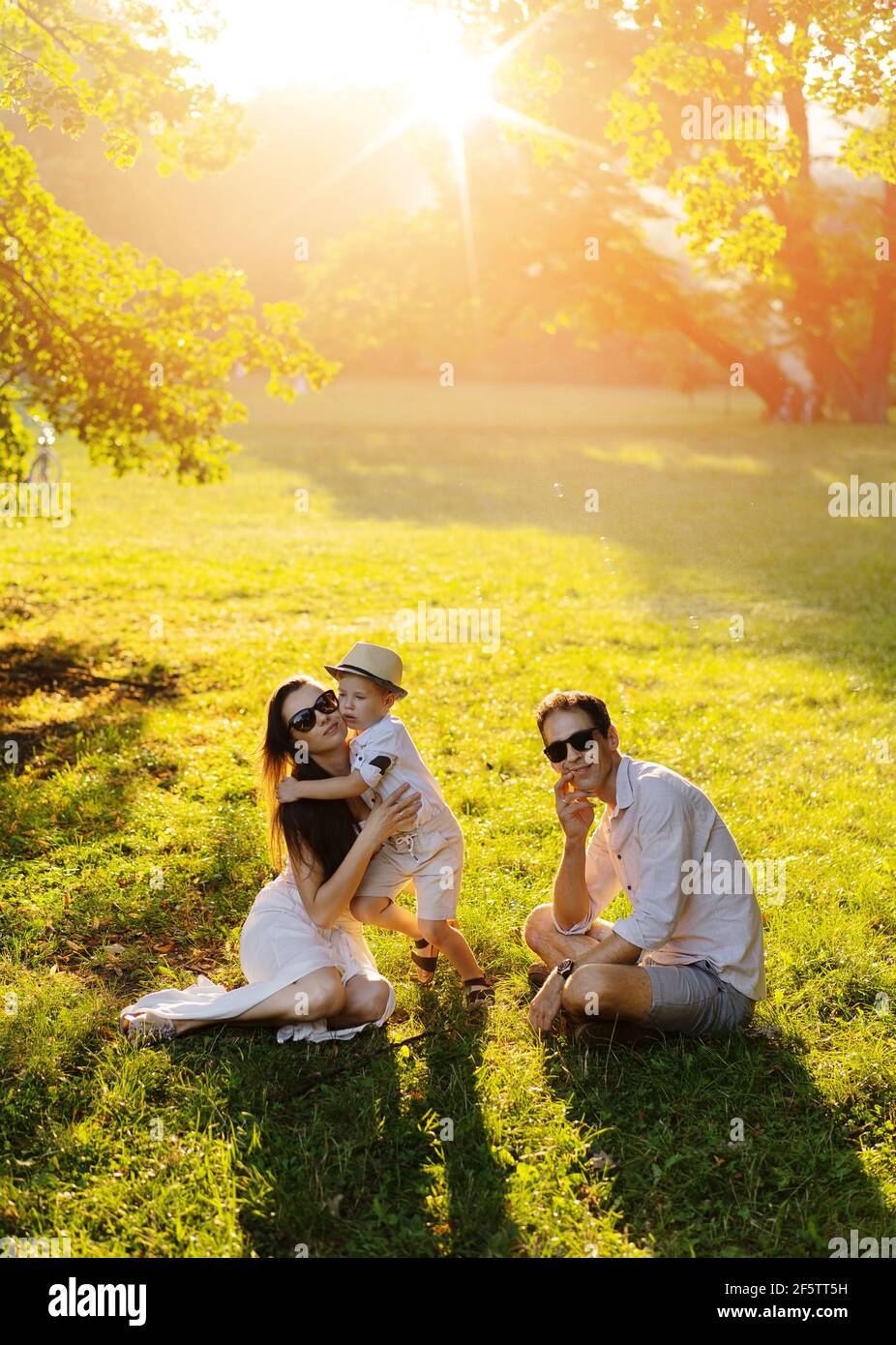 Cheerful family enjotying the summer weather in the park Stock Photo