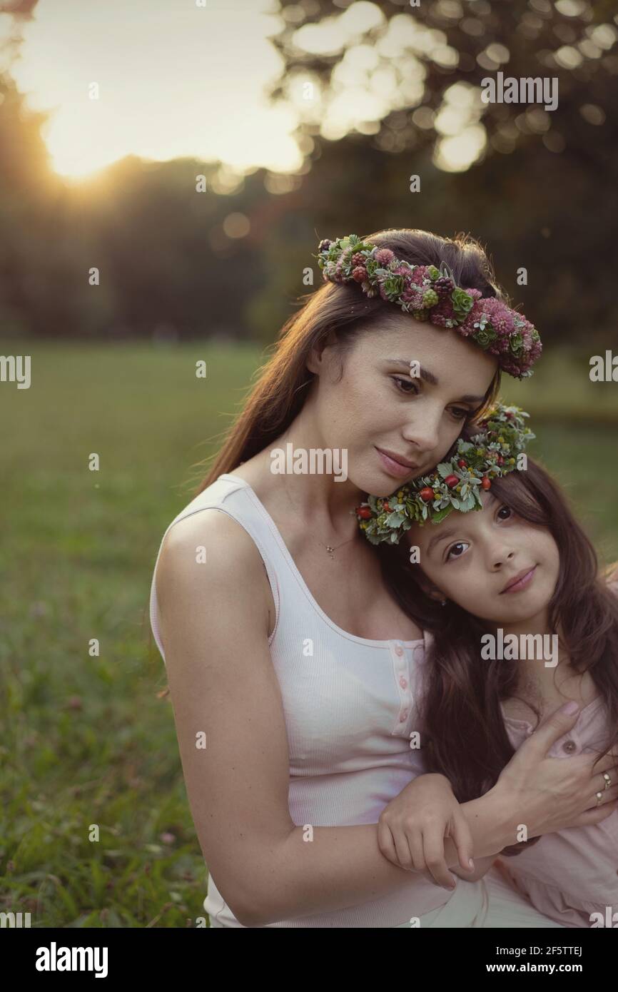 Portrait of a pretty mother hugging her beloved daughter - outdoor concept Stock Photo
