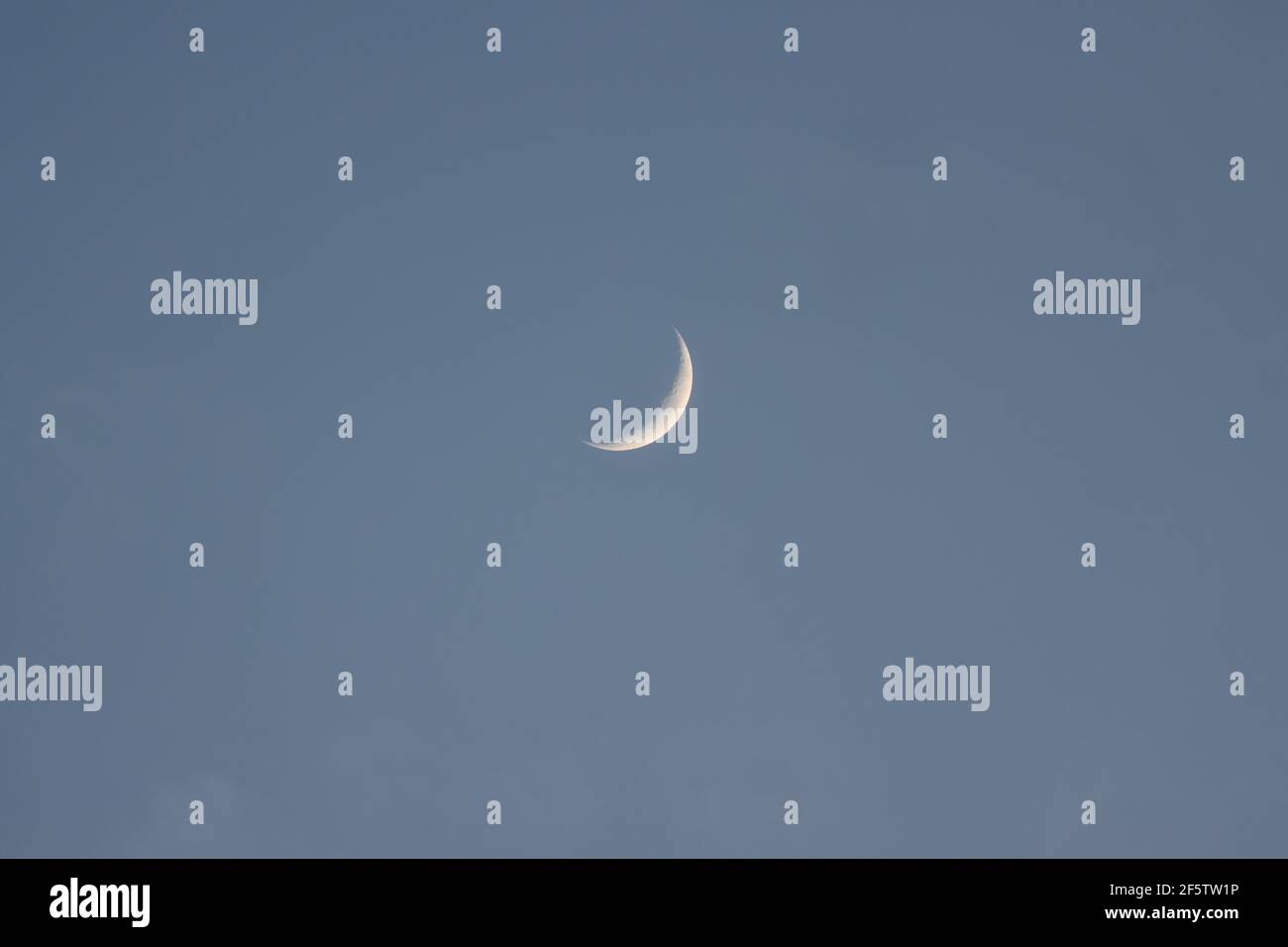 Waxing crescent moon in the evening sky Stock Photo