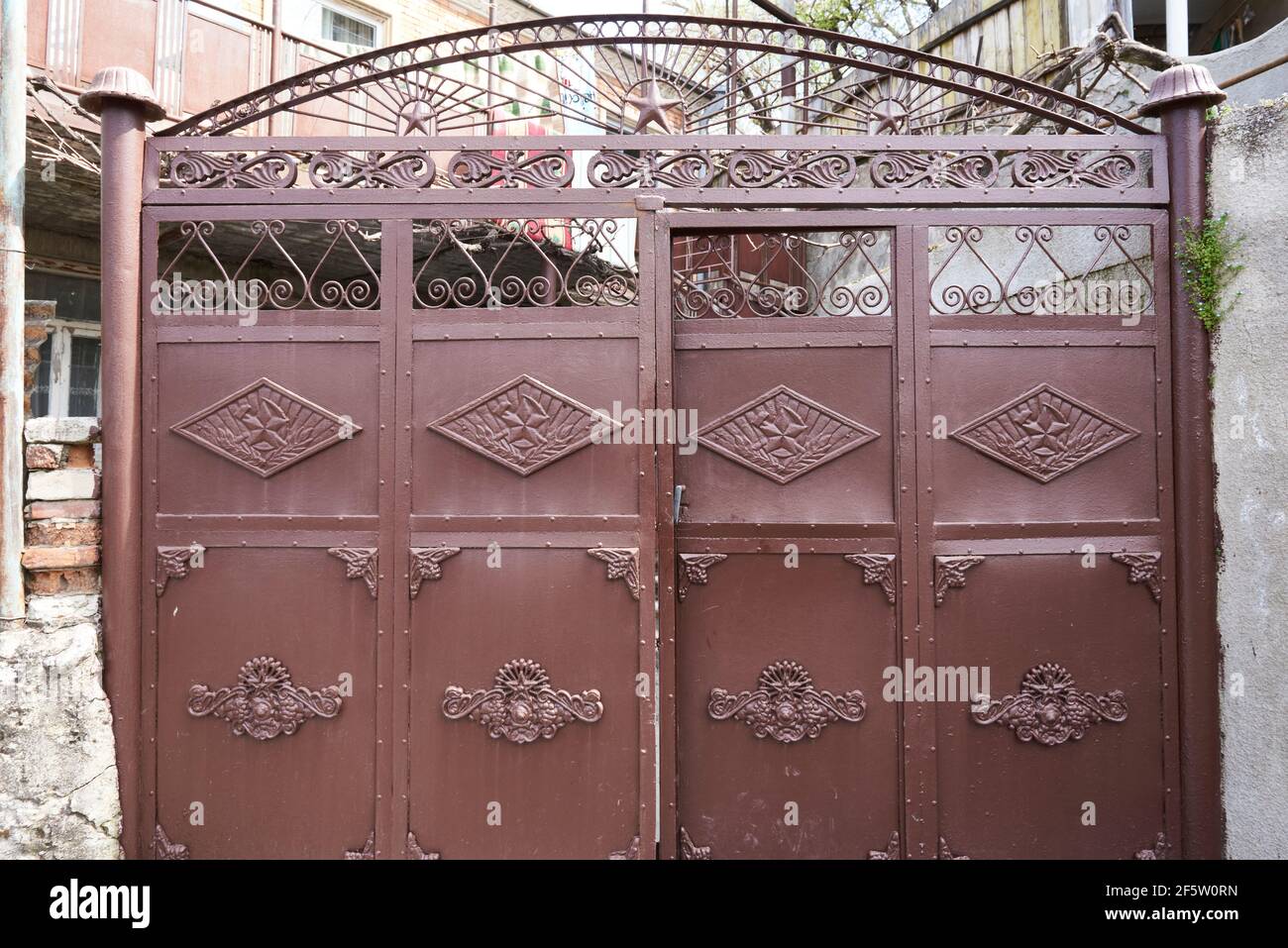 Painted metal brown gate with soviet symbols. Kutaisi. Stock Photo Alamy