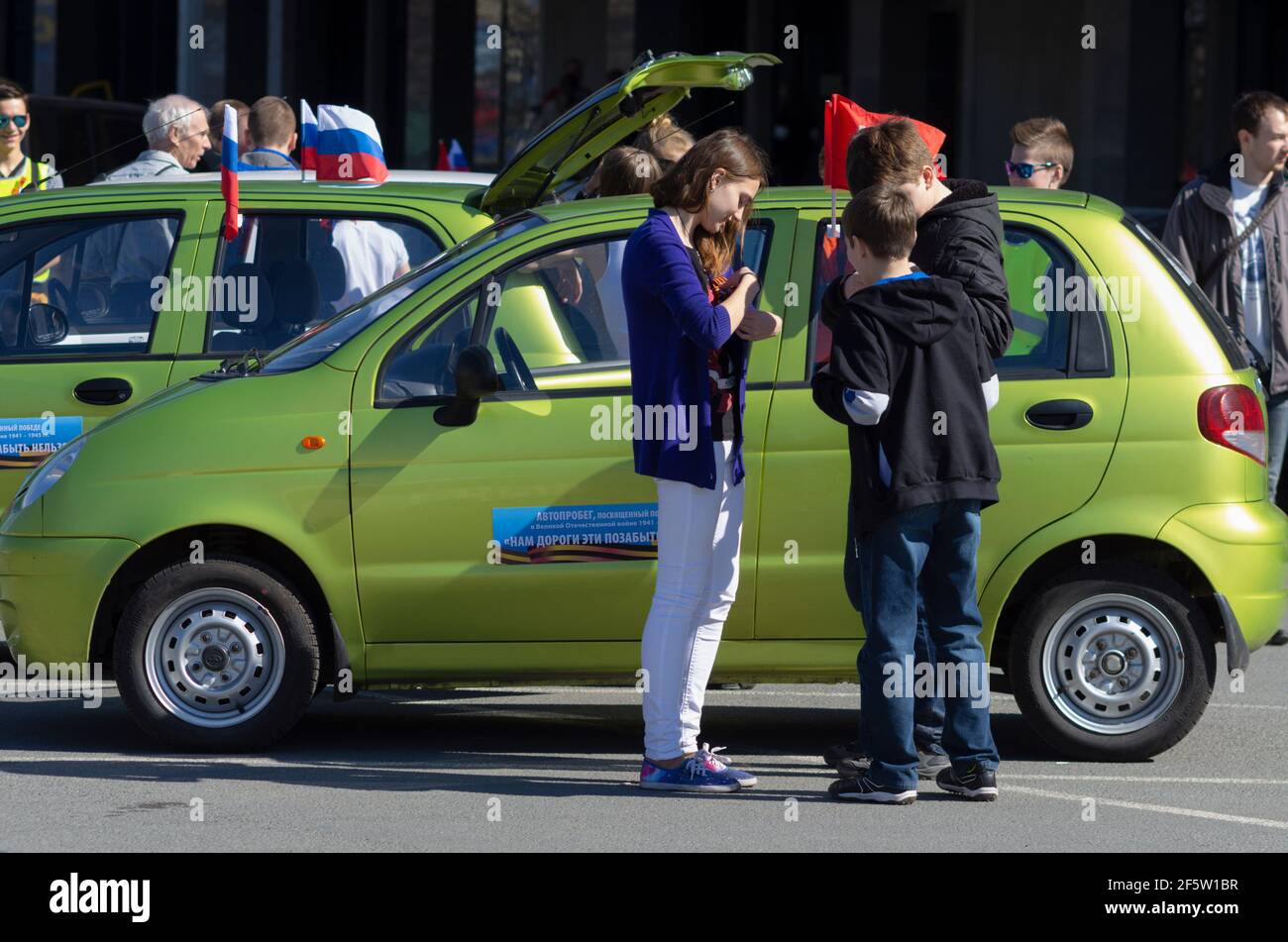 Saint Petersburg, Russia - May 05, 2016: Teenagers participating in the annual rally in small cars Daewoo Matiz in memory of the Great Patriotic War 1 Stock Photo