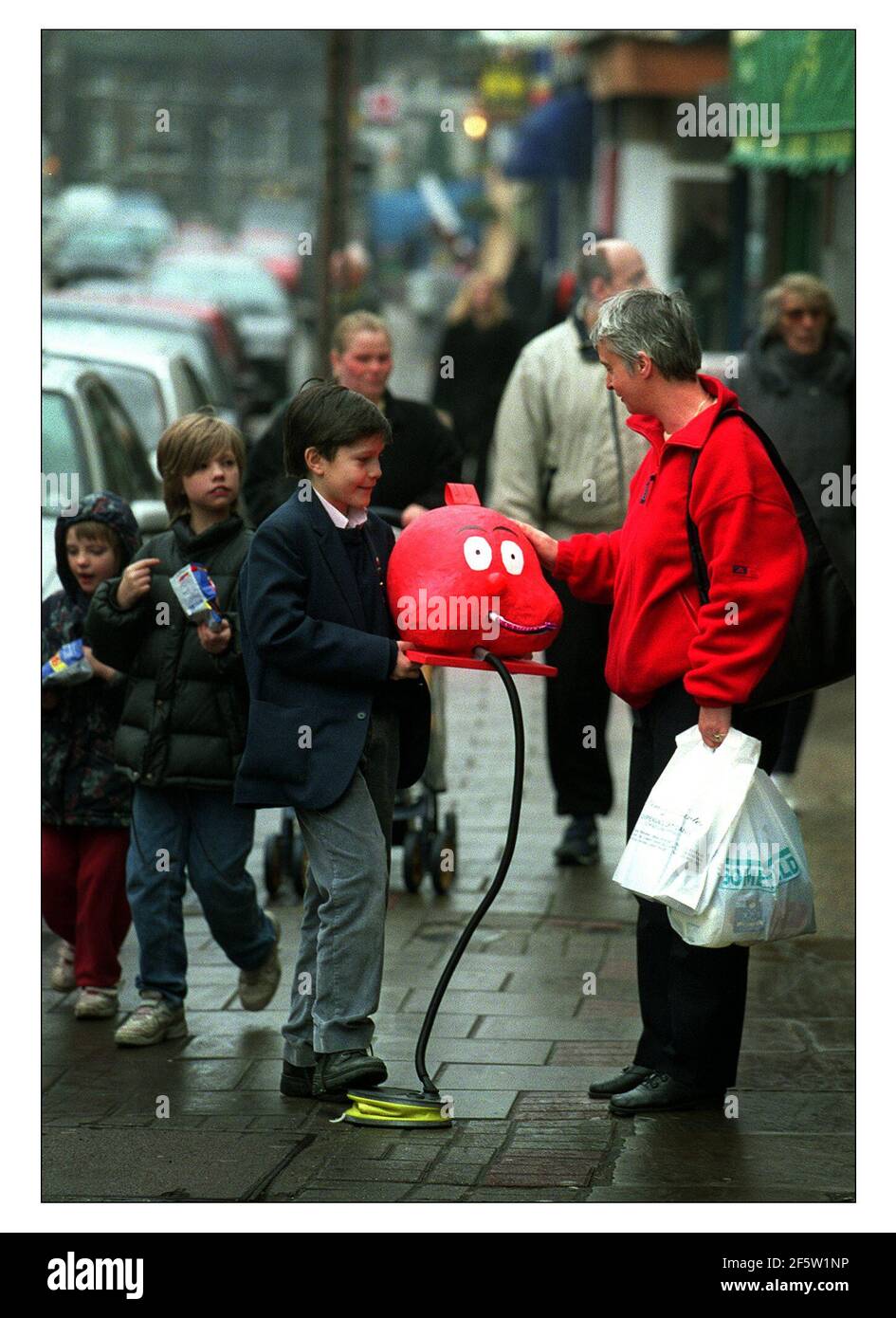 Eleven year old Edmund Cuthbert of Herne Hill gladly recieves a donation for Red Nose day. He has used his own initiative and ability to build a selection of donation boxes. he or his mother can be contacted on 0207 737 3269. Stock Photo