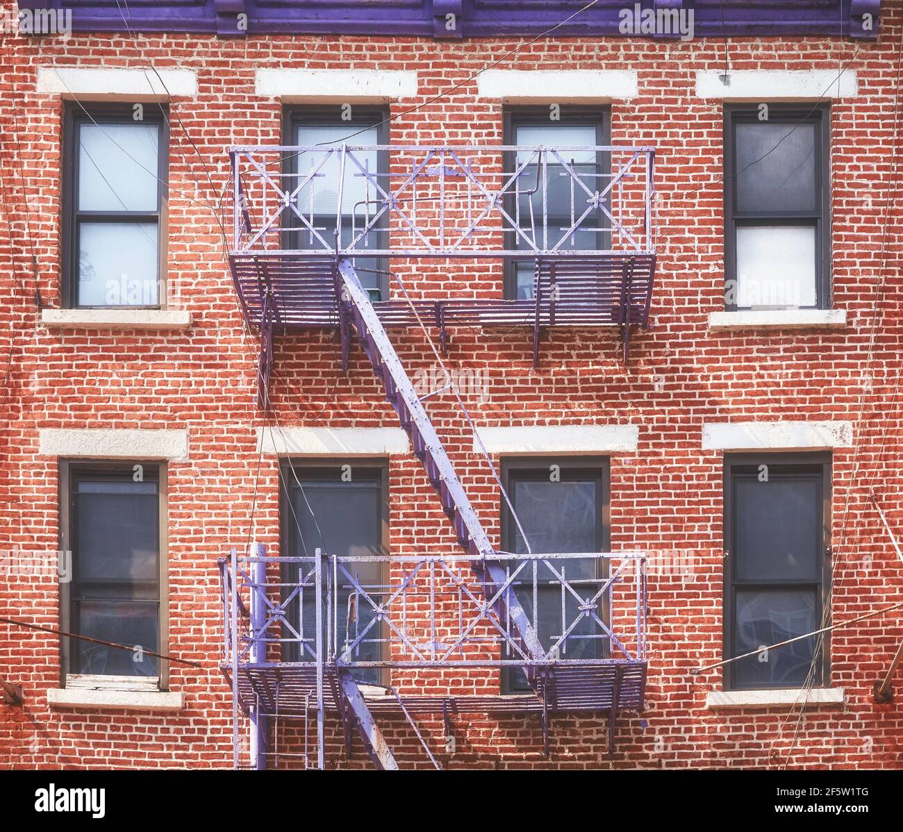 Old red brick building with iron fire escape, New York City, USA Stock