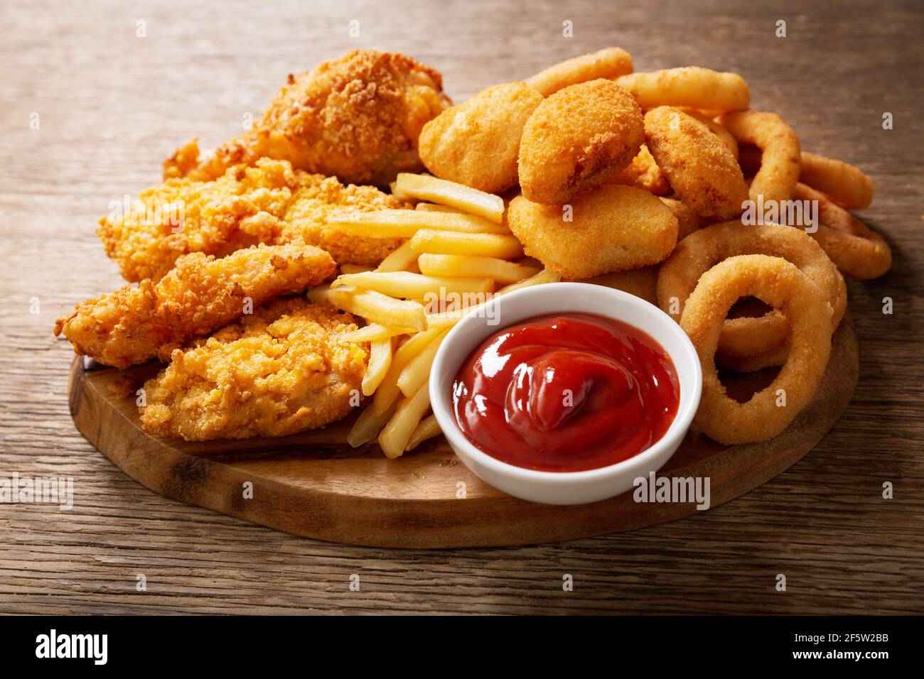 fast food meals onion rings, french fries, chicken nuggets and fried