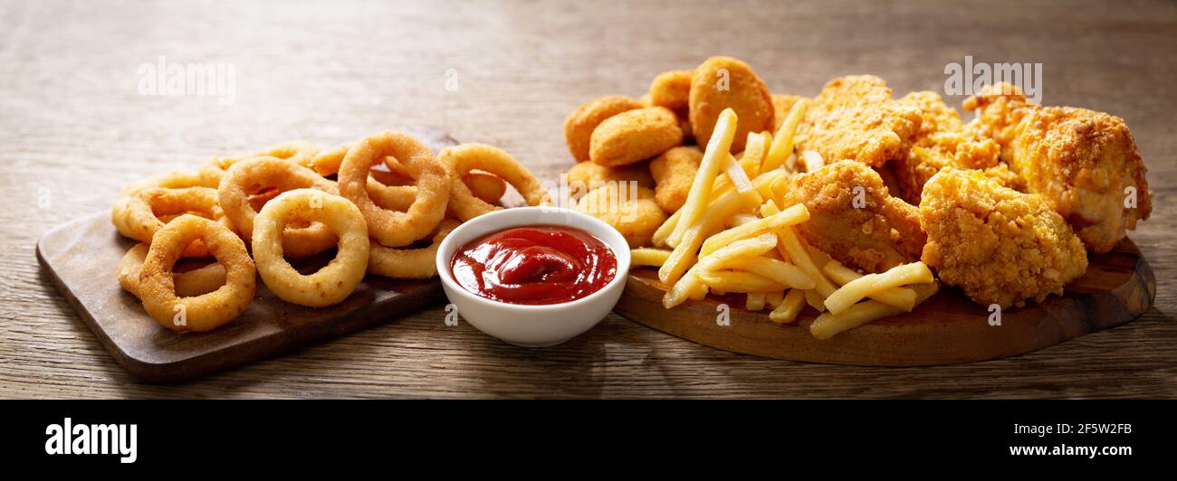 fast food meals onion rings, french fries, chicken nuggets and fried