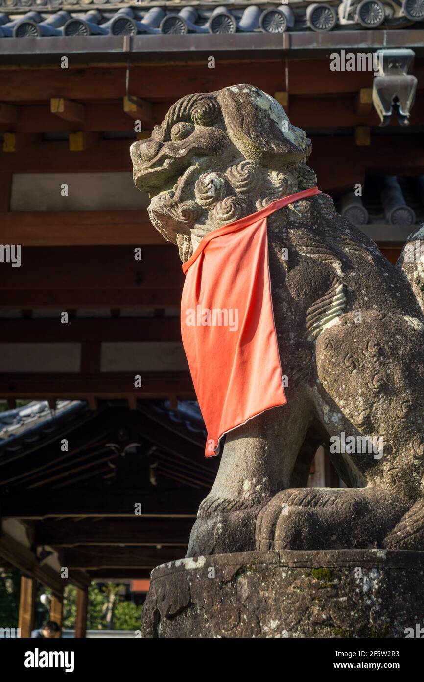 A komainu liondog statue guarding the entrance to Himuro Jinja shinto