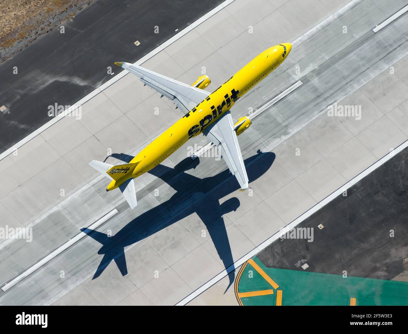 Aerial view of Spirit Airlines Airbus A321 aircraft departing international airport. High view of yellow airplane taking off. Airplane N657NK . Stock Photo