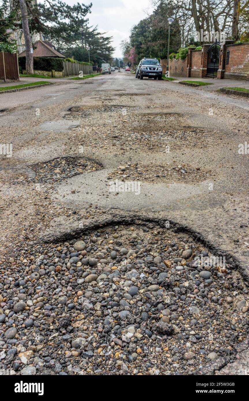 Potholed road in bad state of repair in South London. Stock Photo